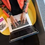 Person Using Macbook Pro and Python book