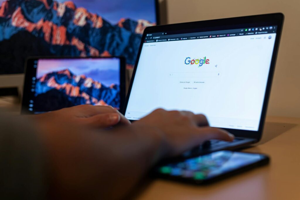 Close-Up Shot of a Person Using a Laptop to search Google for SEO